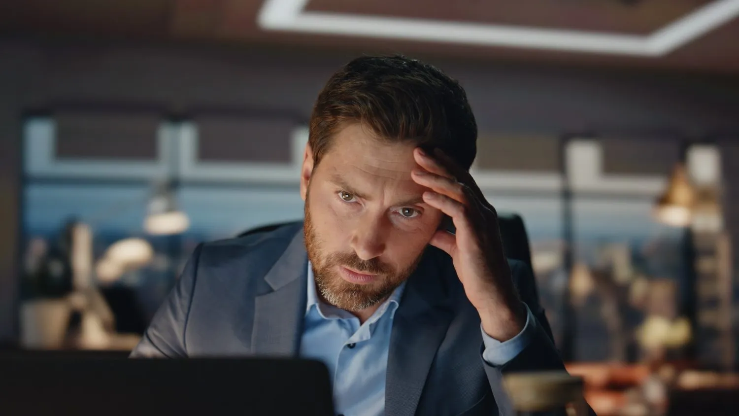 A stressed man working late in the office